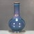 A beautiful Chinese porcelain bottle vase featuring a classic Jun ware style flambe glaze. The vase has a bulbous body and...