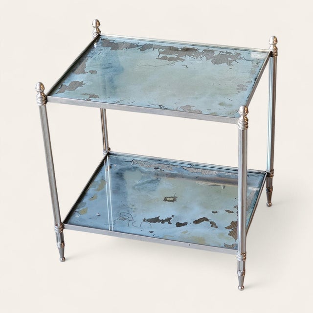 Mid-20th-century chrome-plated side table in the style of Maison Jansen, featuring elegant turned legs, spherical finials,...