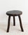 Vintage Brutalist tripod stool in solid wood, circa 1950. Slightly curved circular seat resting on three wooden legs....