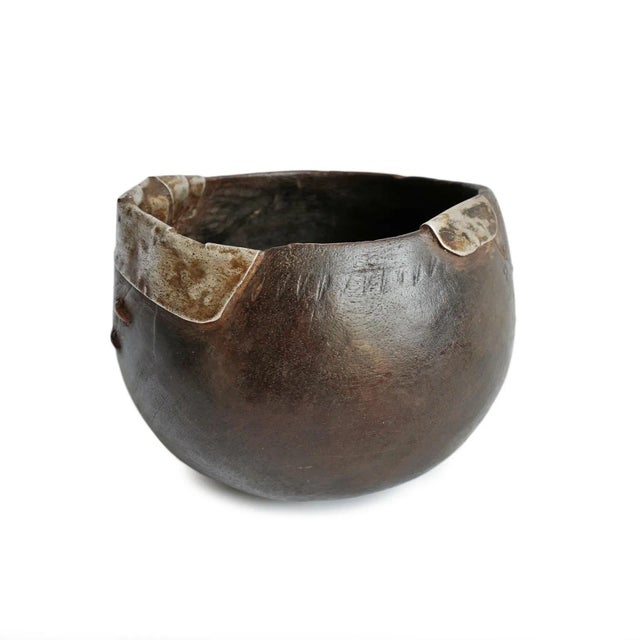 Vintage handmade village pitcher from Africa. Rich dark wood with original aluminum repairs and traditional geometric...