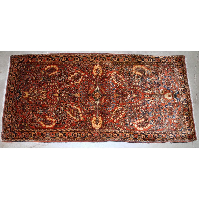 Handmade antique Persian Sarouk rug in original good condition. The rug is from the beginning of 20th century made in red...