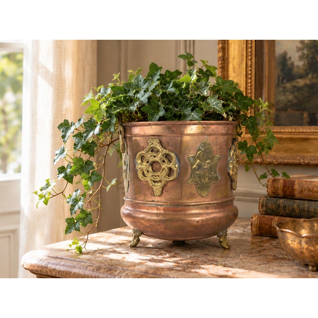 Antique copper jardiniere dating to the late 19th or early 20th century, featuring ornate brass mounts with Gothic-...