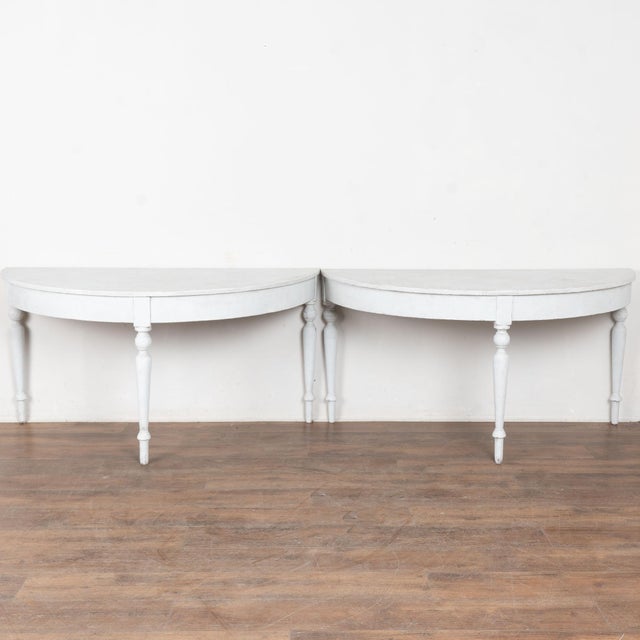 Pair, Gustavian large demi-lune side tables that are each just under 5' wide at back. Turned legs add to the simple grace...
