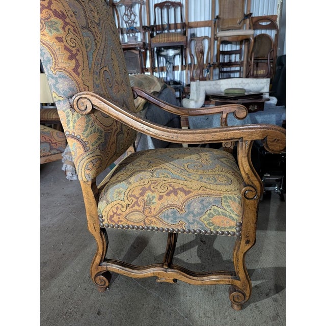 Infuse your space with bohemian elegance and Old World charm using this vintage French Provincial armchair and its...
