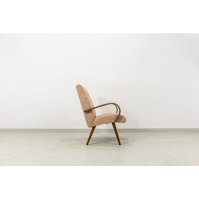 This Armchair Type 53, designed by J. Šmidek for TON in 1960s Czechoslovakia, is a standout piece. Its distinguishing...