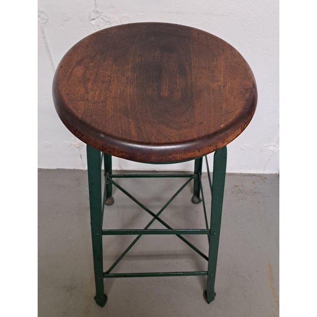Vintage Angle Steel Factory Stool. It is 30.25" high and the legs are 15" apart. The seat width is 13.5". Seat has been...