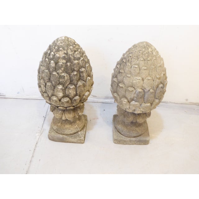 This pair of cement garden finials have an old weathered patina and weigh about 100 lbs each.