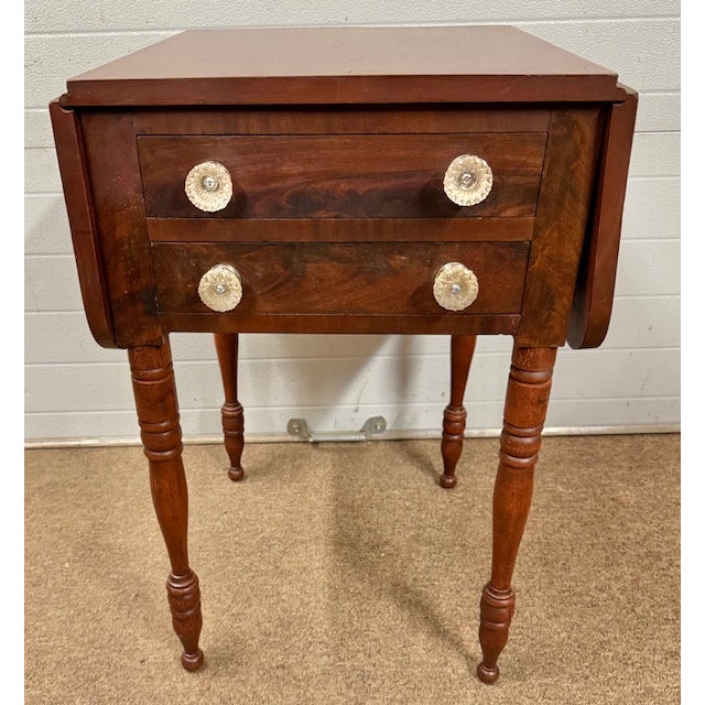Nice cherry and flame mahogany antique American 2 drawer Sheraton dropleaf work table. Table has beautiful delicately...