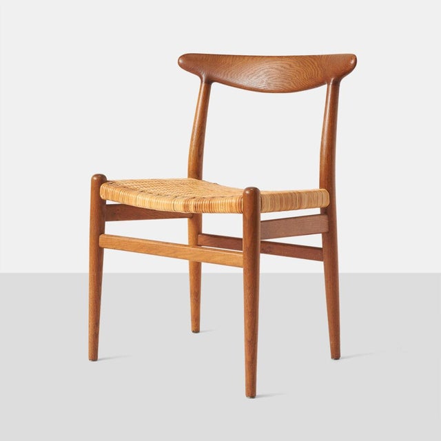 Oak & Cane W2 Chairs by Hans Wegner Denmark, c1950s A set of 5 stained oak and cane dining chairs. Each chair frame is...