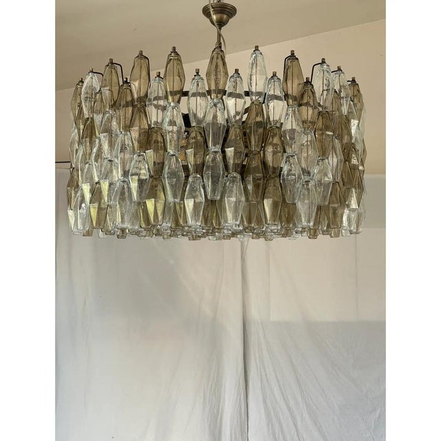 Contemporary italian chandelier with tranparent and fume’ “poliedri” murano glass . this round chandelier showcases a...