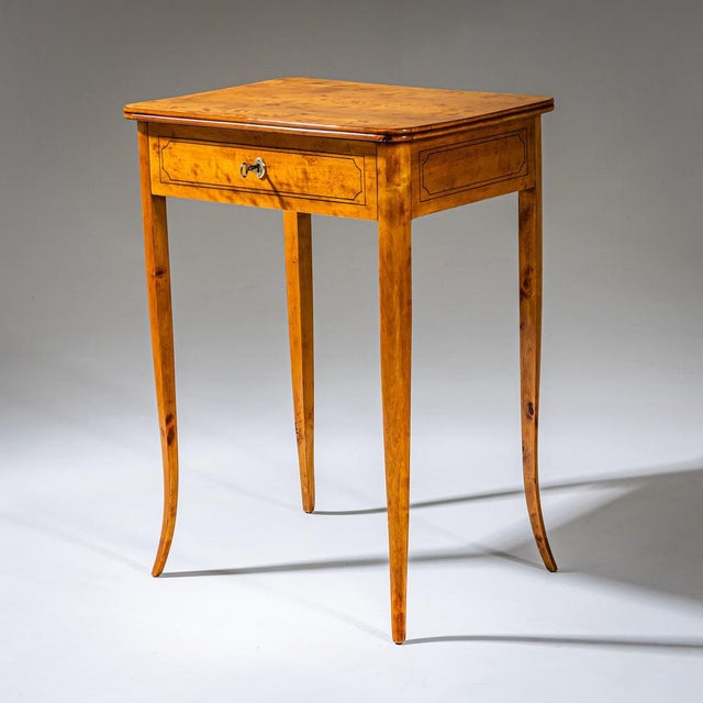 Small Biedermeier sewing table with one drawer, raised on tall, elegantly curved legs. The apron is decorated with fine...