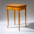 Small Biedermeier sewing table with one drawer, raised on tall, elegantly curved legs. The apron is decorated with fine...
