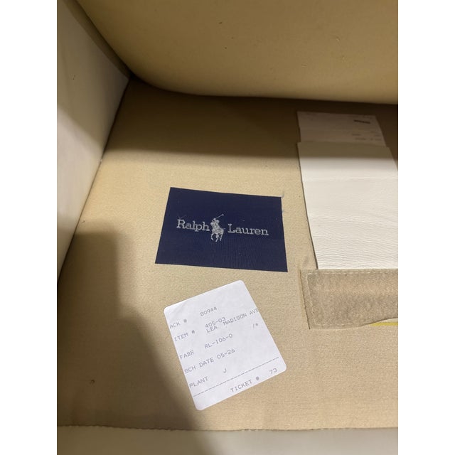 A pair of white vintage Ralph Lauren leather club chairs with purple buttons on the backs of the chairs. Vintage Ralph...