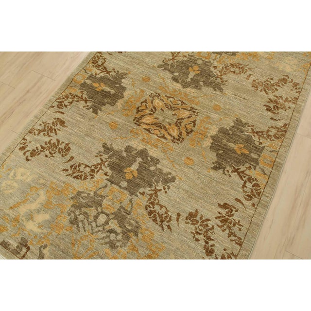 A modern traditional Suzani rug hand-knotted with fine wool on a cotton foundation. This rug features a central medallion...