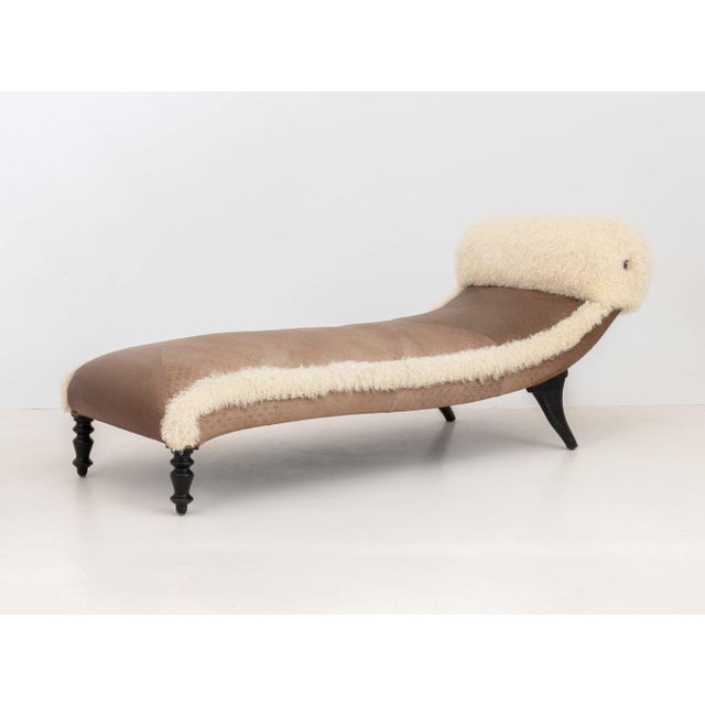 Embossed Leather and Flokati Wool Upholstered Chaise Longue, on four turned wood feet terminating in casters. 29" H x 72"...