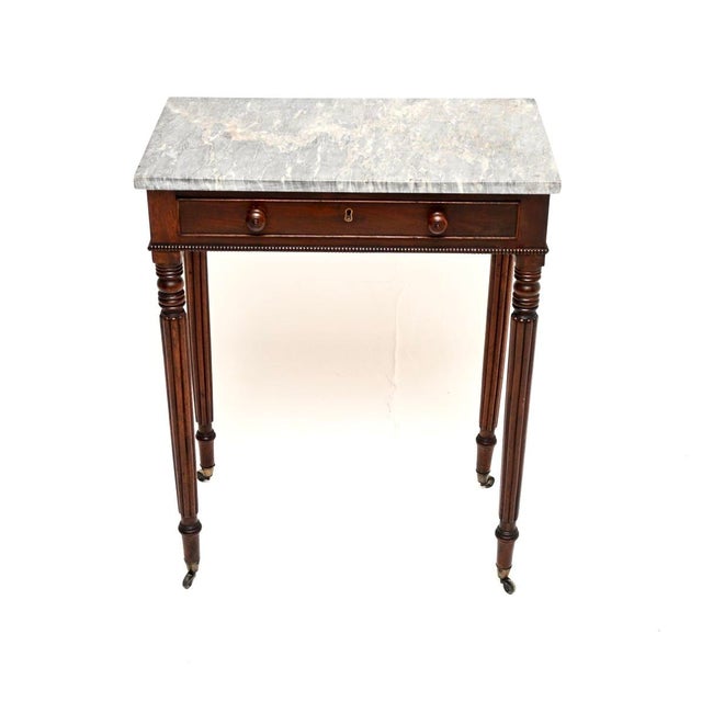 A wonderful antique Regency period marble top side table. This was made in England, it dates from around the 1815-1830...