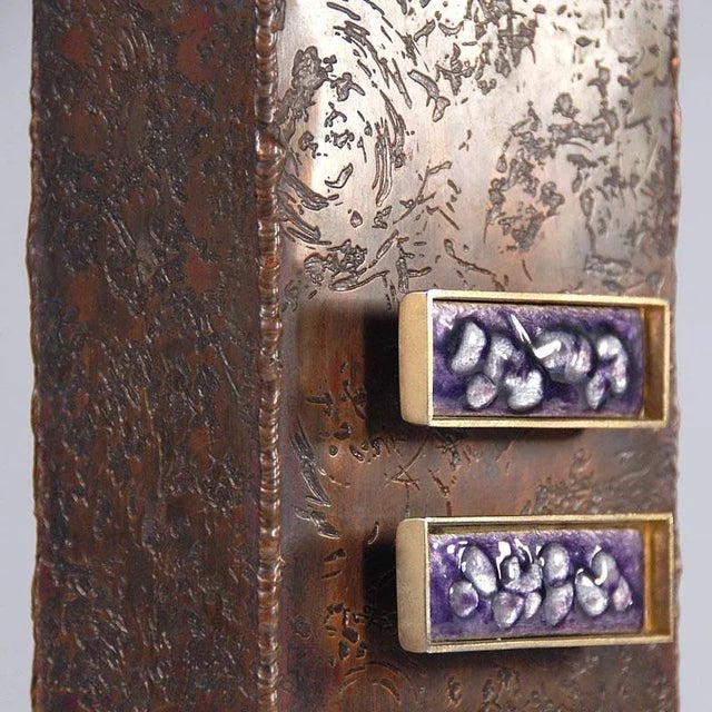 It is made by hand from heavy etched copper plate. The decorative brass plaques are decorated with colored enamel.