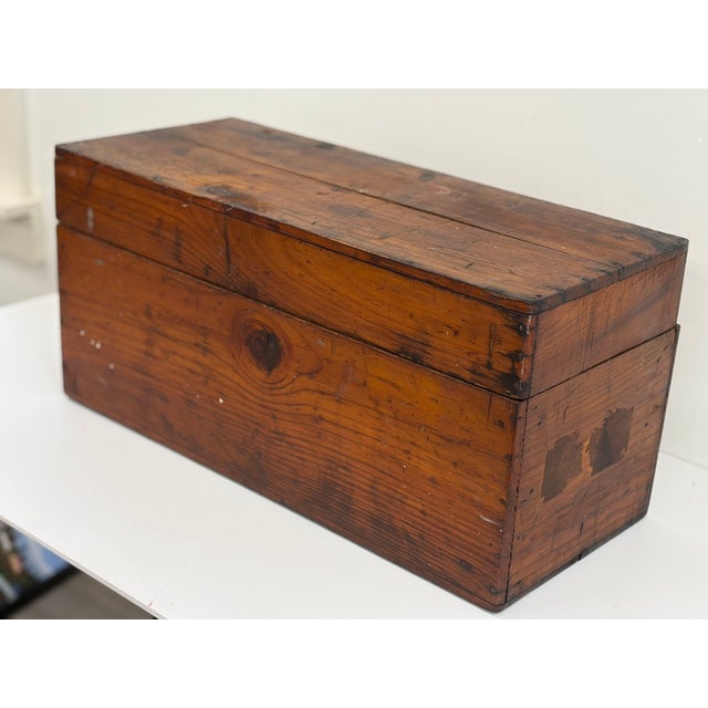 Handmade American pine storage box dating to the first half of the 19th century. Constructed from wide pine boards with a...
