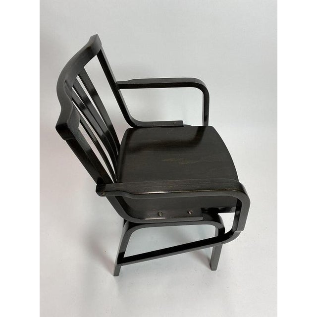 Black mid-century design armchairs by TON Bystrice pod Hostýnem 1950s. Professionally stained and repolished. This piece...