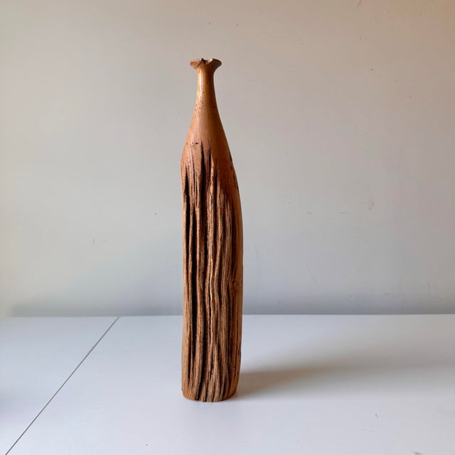 Tall turned live edge wood bottle vase. The piece has a lovely hand turned top with flared bottle neck top. The vase...