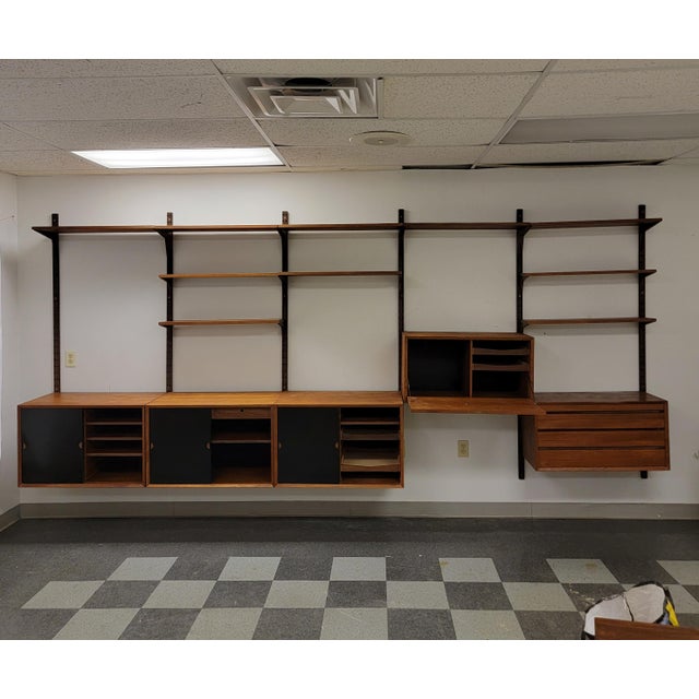 A 5 bays wall unit by Poul Cadovius Made in Denmark Circa 1960 Featuring : 6 large shelves: 11.75" D 4 small shelves:...