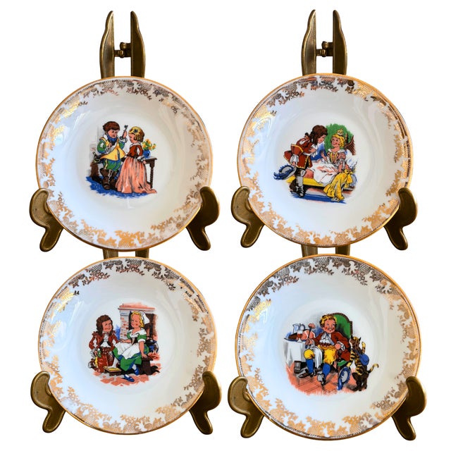 A delightful quartet of mid-century French porcelain dessert plates, each telling a story through vivid colors and...