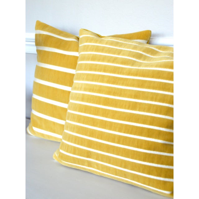 The geometric patterns of the cotton velvet and the raffia style of the woven details make this line of pillows absolutely...