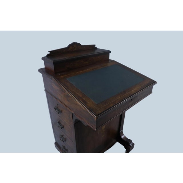 Beautiful antique late Victorian era rosewood davenport desk with marquetry on the front panel and down both sides. The...