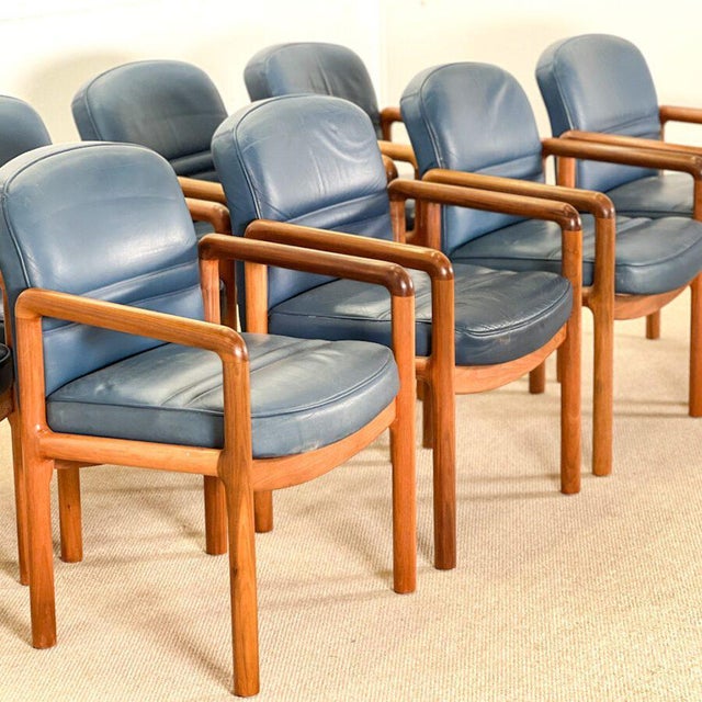 This distinguished set of eight armrest dining chairs, designed by Gordon Russell in the 1960s, exemplifies the refinement...