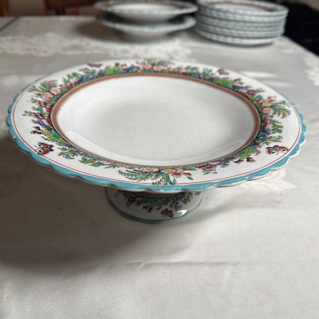 Opaque Porcelain Footed Plate. 10” diameter by 4.125”high. Some small paint chips on rim of plate and 2 chips on back rim...