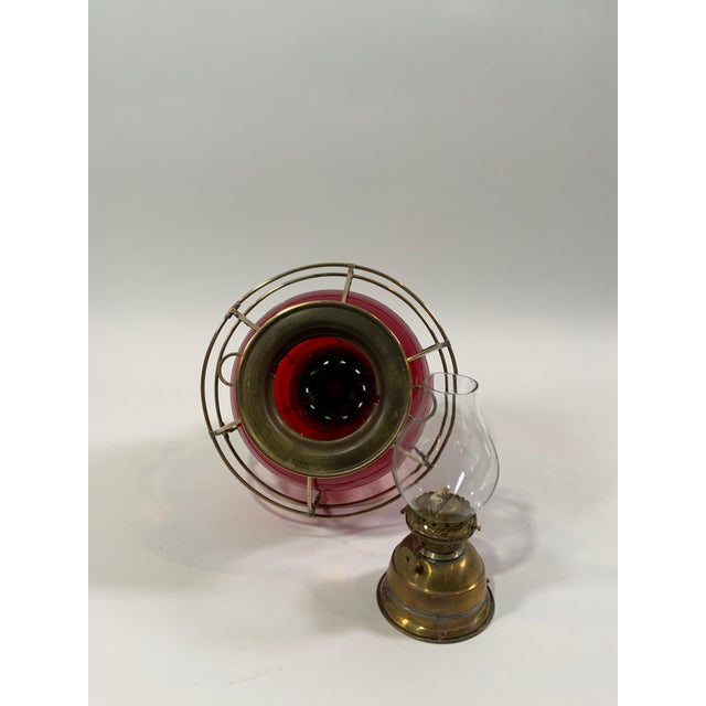Solid brass Perkins eight-inch onion lamp with red lens. Highly polished. Oil burner with wick, tank, and glass chimney....