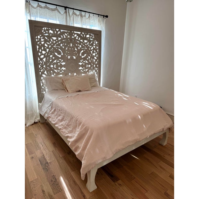 Crafted from richly grained tropical hardwood, this hand-carved bed frame brings timeless elegance to the bedroom....