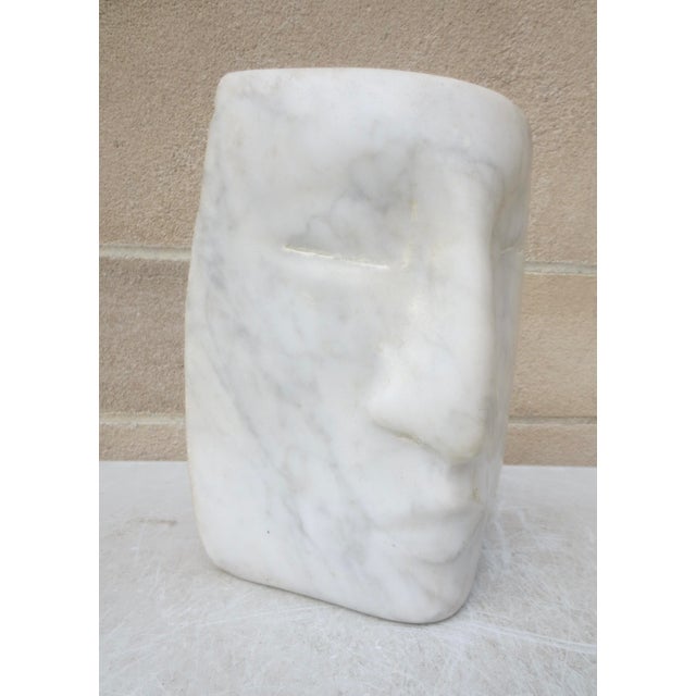 Jochen Sendler:( Germany 1939): Solid block of white marble in a triangular construction of the human face. In a soft...
