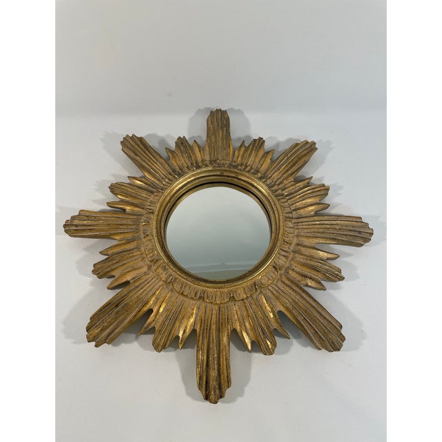 A stunning 16.5" Italian Sunburst Wall Mirror from the 1960s. This Mid Century Modern wood mirror features gold leaf paint...