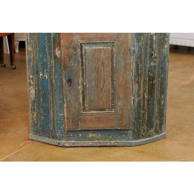A Swedish Gustavian period painted wood wall hanging corner cabinet from the late 18th century, with blue paint, single...