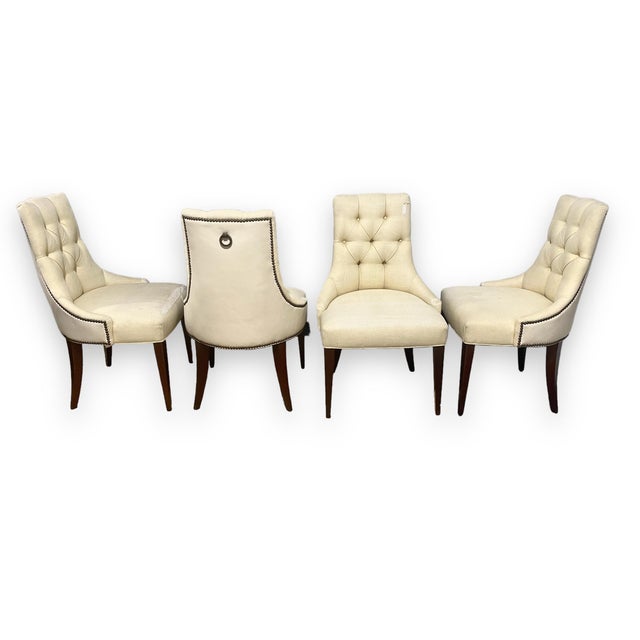 A set of 4 dining chairs designed by Thomas Pheasant for Baker Furniture. These chairs were inspired by salon chairs of...
