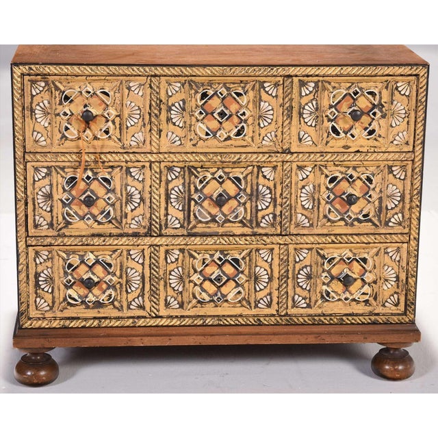 20th century, three drawers on round turned feet, carved and paint decorated door fronts, label reads "Wm A. Berkey...