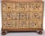 20th century, three drawers on round turned feet, carved and paint decorated door fronts, label reads "Wm A. Berkey...