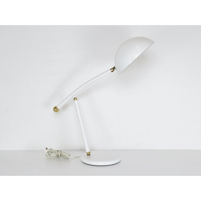 Vintage enameled metal and brass adjustable desk lamp. Adjusts in 3 places (at base, elbow, and shade). Great modern...