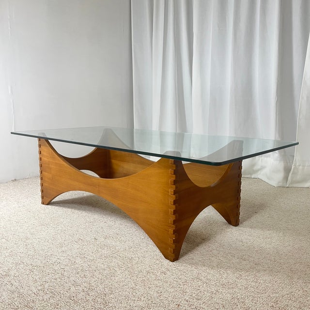 Exceptional vintage coffee table with a sculptural design, crafted from mahogany (likely sipo or khaya) and topped with a...