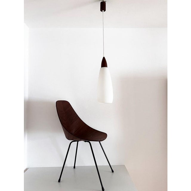 Beautiful glass and teak wood pendant lamp from the mid-century. Made in Italy in the 1960s. Fine craftsmanship on the...