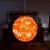 Vintage chunky lucite swag pendant light with a rounded globe form and layered translucent acrylic panels in bright orange...