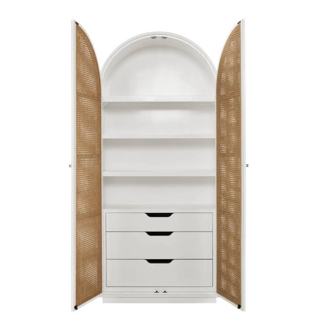 Modern, elegant arched cabinet. The main body of the cabinet is a clean, crisp white. It features a distinctive rounded,...