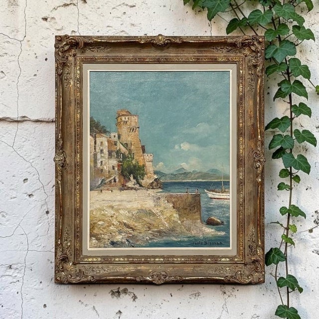 “Adriatic Coastline” by Belgian artist Paule Bisman captures the romance of antique village houses gathered beneath a...