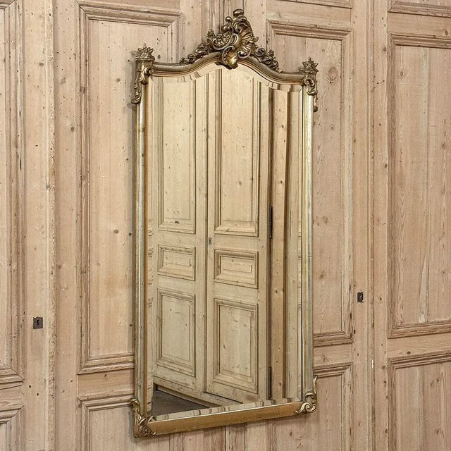 Antique French Louis XV Giltwood Mirror adds the elegance of the Rococo and Baroque movements to any decor! Featuring an...
