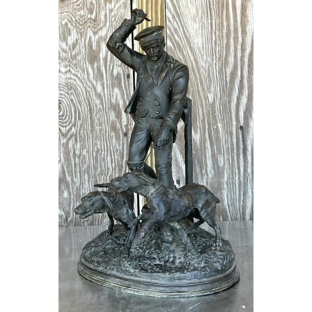 Evoke the rugged charm of the American frontier with this Vintage Boho Patinated Metal Man with Hounds Sculpture. Crafted...