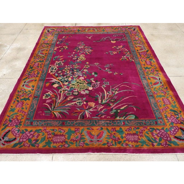 This exquisite Mid-20th century Chinese Nickles Art Deco rug, features a lush magenta field adorned with a beautifully...