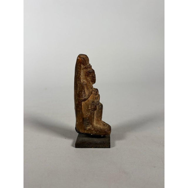 Terracotta sculpture, statuette of the goddess Isis lactans, 28th Dynasty period, 7th-4th century BC. Rests on a black...