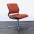 This Steelcase chair features a bright orange cushioned seat and backrest with a sturdy metal base. It offers reliable...