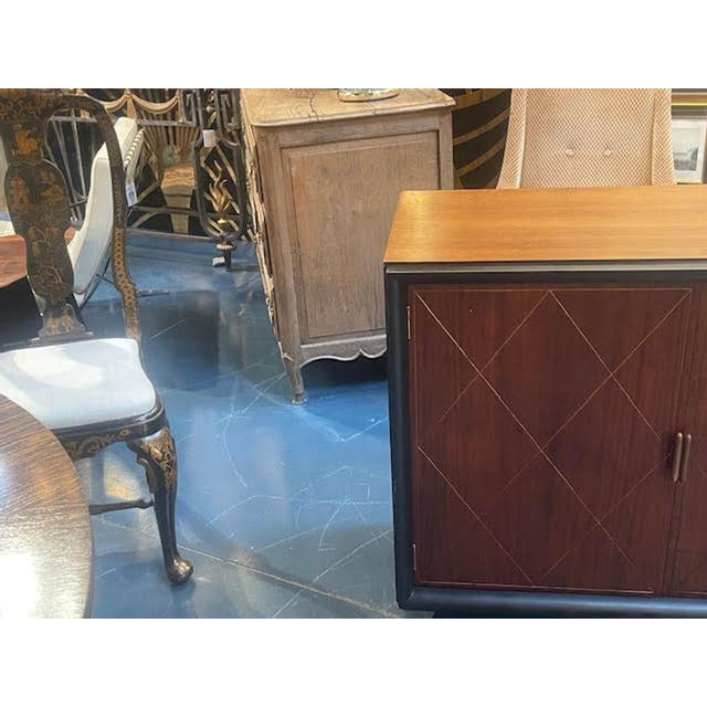 This product is a pair of French MCM brass inlaid mahogany and ebony side cabinets. They feature an elegant combination of...